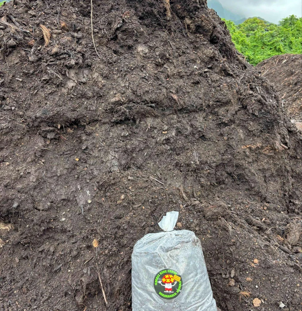 Spent mushroom compost pile with a Small Kine Farm bag